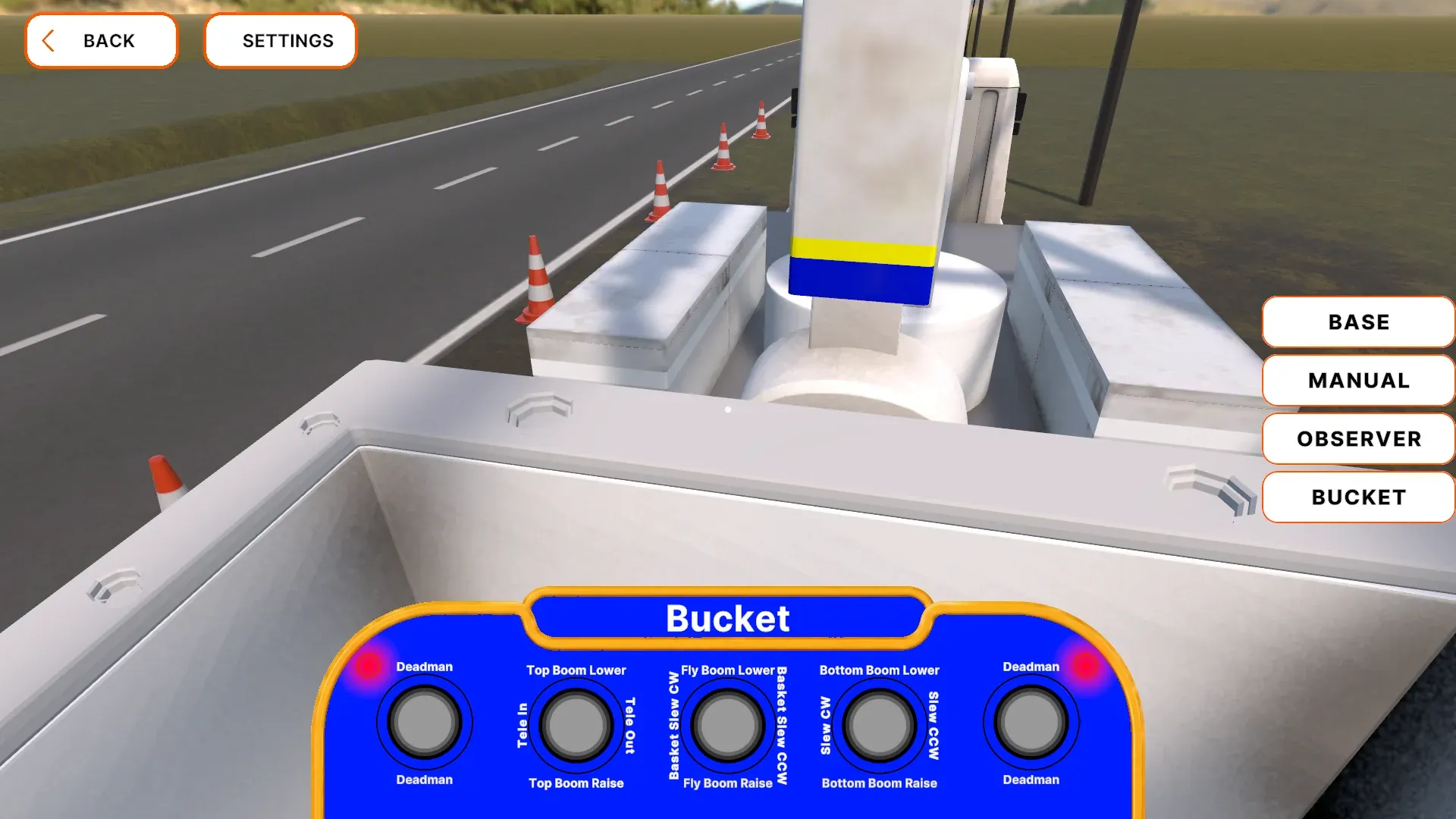 First-person bucket view with a blue control panel and joystick inputs.